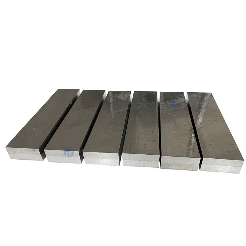 Hardmetal tips brazed wear resistant plate.